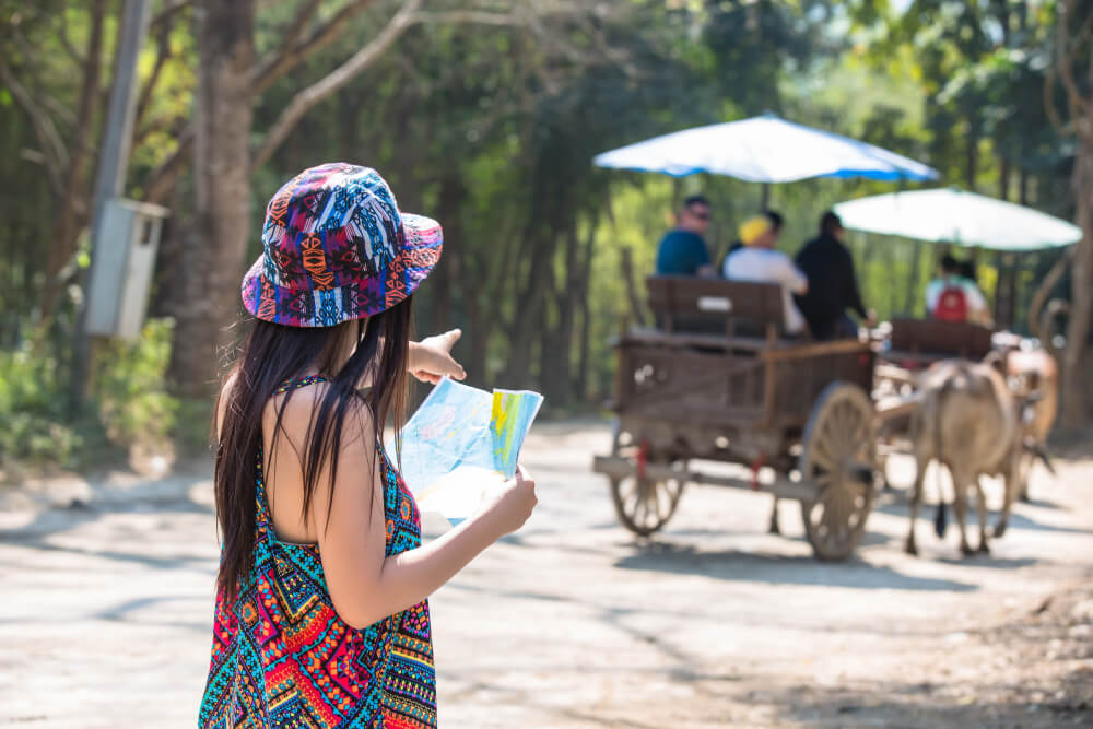 a woman tourist looking a travel map