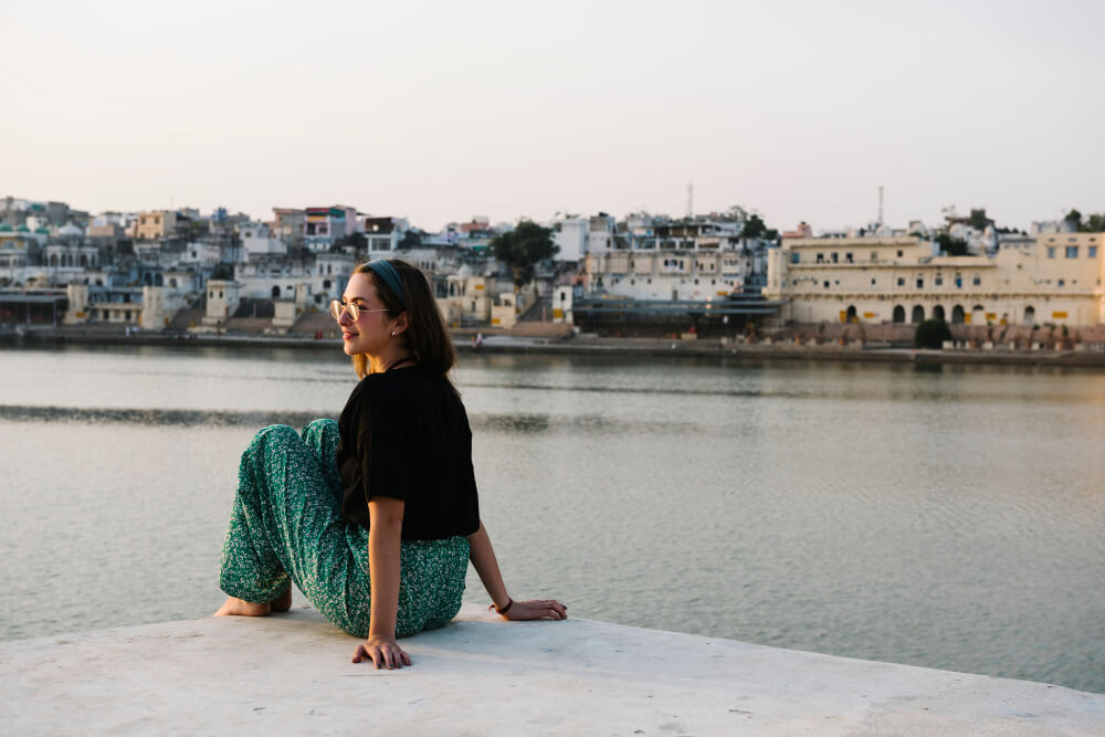 a woman posing over an indian city