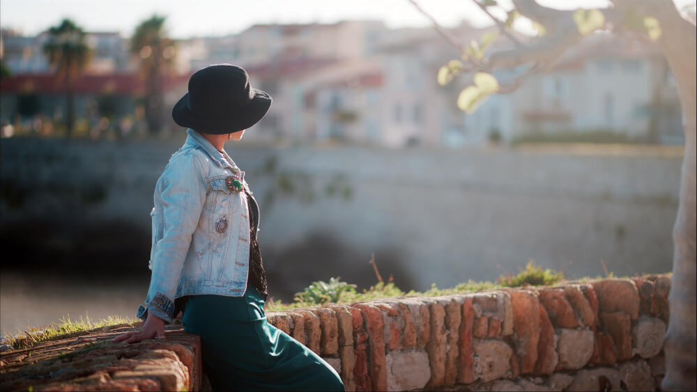 a woman on a wall looking at the old city